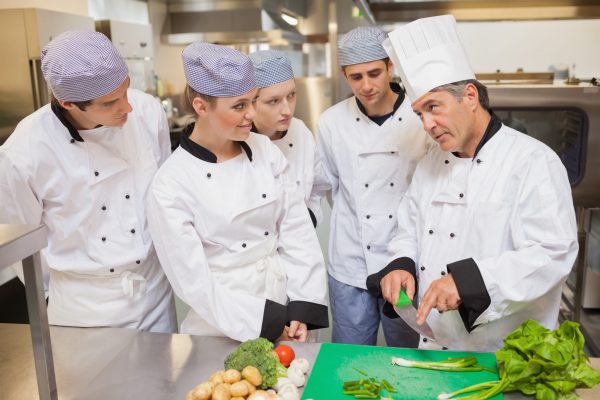 Trainees,Learning,Vegetable,Slicing,In,The,Kitchen